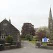 General view from street with hall on the left and church on right.