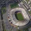 Oblique aerial view centred on the football stadium, taken from the E.