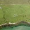 Oblique aerial view centred on the ruins of the chapel and the burial ground at Kilnave, Islay, taken from the ESE.