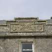 South front.  Detail of carved panel on parapet.