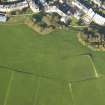 Oblique aerial view of the slight earthworks on the site of Clockmill House, Holyrood Park, taken from the SSW.