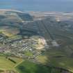 General oblique aerial view of Leuchars village and airfield, taken from the NW.