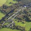 Oblique aerial view centred on the mills with the cottages adjacent, taken from the WNW.