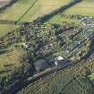 Oblique aerial view centred on the mills with the cottages adjacent, taken from the SE.