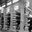 Copy of photograph of paper making machine (no.6), Calender Stack, the rolls running in collar-oiling type bearing blocks and carried in open type frames. All rolls are fitted with VICKERY doctors of the latest type. Pressure is applied by means of air cylinders, and the rolls area raised by means of motors through suitable reduction gearing. Control of the equipment is conveniently operated at the front of the machine and the pressure is applied at each point is indicated on the respective panel, from the JB&S Machine 161 catalogue, James Bertram and Son Ltd, Leith Walk, Edinburgh, circa 1953. The catalogue describes and illustrates some of the features of the No 161 machine 'recently installed at the well known Mill of Guard Bridge Paper Co Ltd, Fife , Scotland designed with the co-operation of the Mill Staff especially for the economical production of the highest quality papers...'
