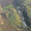 Oblique aerial view centred on the remains of the fort with the farmstead adjacent, taken from the W.