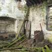 Interior, dining hall and cook house showing cooking range and the remains of a boiler (?) at N end of the building.