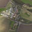 Oblique aerial view centred on the village with the parish church adjacent, taken from the SE.