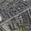 Oblique aerial view centred on the N end of Leith Walk with the former tram depot adjacent, taken from the NW.