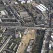 Oblique aerial view centred on part of  Leith Walk with the site of the tram and bus depot adjacent, taken from the NW.