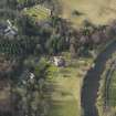 Oblique aerial view centred on the country house with the walled garden adjacent, taken from the SE.