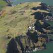 General oblique aerial view of St Abb's Head Lighthouse with the defended promontary and possible nunnery in the background, taken from the E.