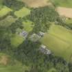 General oblique aerial view centred on the house and stables, taken from the SW.