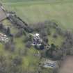 Oblique aerial view centred on the country house with the walled garden and stables adjacent, taken from the NNW.