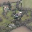 Oblique aerial view centred on the country house with the walled garden and stables adjacent, taken from the NW.