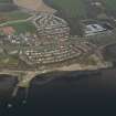 General oblique aerial view centred on the town with the pier adjacent, taken from the SW.