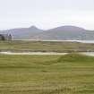 Distant view to Vallay House, with N Uist visible beyond, taken from WNW