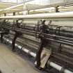 Interior. Former winding shed, view of no. 14 loom producing screen cloth. Bought second hand in the 1980s. The jaquards of this 8 point, 432 inch loom were never installed as it is used to make plain fabrics or screen.