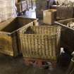 Interior. 1950s block, ground floor, winding shed, detail of basket and tubs for transporting bobbins