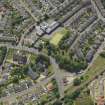 Oblique aerial view centred on the churches (old and new), taken from the N.