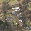 Oblique aerial view centred on the country house with the stable block, taken from the NNW.