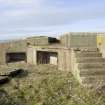 Detail of access steps and ready-use ammunition locker at base of re-used gun emplacement.