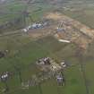 General oblique aerial view centred on the village with the Nuclear power station and airfield adjacent, taken from the ENE.