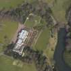 Oblique aerial view centred on the country house with the formal garden adjacent, taken from the SW.