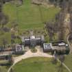 Oblique aerial view centred on the country house with the stable block adjacent, taken from the NNW.