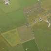 Oblique aerial view centred on the cropmarks of the possible enclosure, taken from the SE.