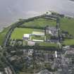 Oblique aerial view of the canal, hospital and stadium in Dingwall, looking E.