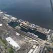 General oblique aerial view of the harbour area, centred on the Victoria Dock taken from the NW.