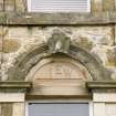 Detail from the North-East elevation of Cumbernauld House, showing the carved stone at first floor level of the central projecting bay.