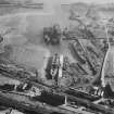 Thomas Ward and Sons Shipbreaking Yard, Inverkeithing.  Oblique aerial photograph taken facing east.  The vessels include a mine damaged large bulk carrier, a small bulk carrier, two large passenger liners and a general cargo ship.