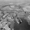Thomas Ward and Sons Shipbreaking Yard, Inverkeithing.  Oblique aerial photograph taken facing west.  The vessels include a mine damaged large bulk carrier, a small bulk carrier, two large passenger liners and a general cargo ship.
