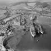 Thomas Ward and Sons Shipbreaking Yard, Inverkeithing.  Oblique aerial photograph taken facing west.  The vessels include a mine damaged large bulk carrier, a small bulk carrier, two large passenger liners and a general cargo ship.