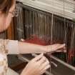 Detail of student working a loom within the weaving studio of the Newbery Tower