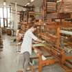 View of students working the looms within the weaving studio of the Newbery Tower