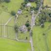 Oblique aerial view of Kirkland, centred on Glencairn Parish Church, taken from the WNW.