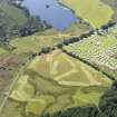 General oblique aerial view of the crannog in Loch Heron with the camp site in the foreground, taken from the NE.