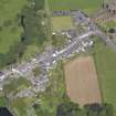 Oblique aerial view of New Abbey, centred on Main Street, taken from the SW.