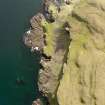 Oblique aerial view of the monastic settlement at Sgor nam Ban-Naomha, Canna, taken from the ENE.