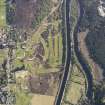 Oblique aerial view of the Caledonian Canal and remains of the military road, field systems and hut circles at Fort Augustus golf course, taken from the ENE.