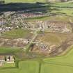 General oblique aerial view of Kirkliston centred on the new housing development, taken from the NE.