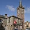 View from south east, showing south elevation of Old Post Office with Clock tower behind.