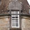 Detail of west dormer window with carved stone pediment at 2nd floor level of south facade