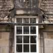 Detail of south dormer window with carved stone pediment at 1st floor level of east facade