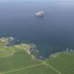 General oblique aerial view of the East Lothian coast centred on Tantallon Castle with the Bass Rock in the background, taken from the S.