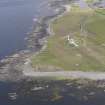 Oblique aerial view centred on the enclosures and lighthouse at Dennis Head, looking SW.