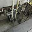 Interior. Locking Room. Locking frame, track side. Detail. Left to right, lever tails (top) attached to links attached to vertical or pedestal 'L' cranks. The left hand tail is c. 18 inches usually for points and the one on the extreme right top of picture is about 27 inches in length and would be for signals. The switch boxes on the right are electric signal switches. The chains on the right are chains for the signal wires with its signal chain pulley.
